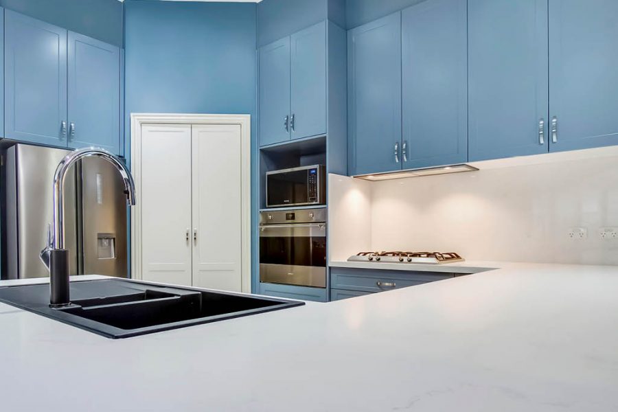 Rouse Hill Shaker Kitchen Stone Benchtop with Blue Cabinets and White Pantry Cupboard